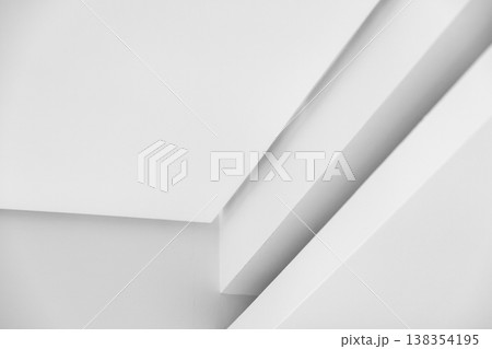 Minimal white architectural ceiling detail featuring intersecting planes, soft shadows 138354195