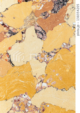 Vertical photo of artificial yellow marble texture showing colorful random veining Vertical photo of artificial yellow marble texture showing colorful random veining 138354205