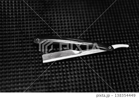 An Antique Grooming Scene With Sharpened Razor On Textured Mat And Leather Strop In Soft Lighting Atmosphere 138354449