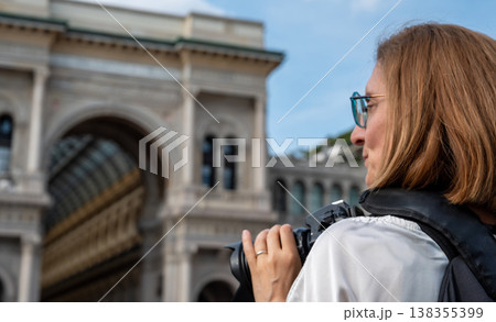Solo traveler photographing the galleria vittorio emanuele ii in milan on a sunny city break, enjoying urban exploration, architecture, culture and leisurely sightseeing Solo traveler photographing the galleria vittorio emanuele ii in milan on a sunny city break, enjoying urban exploration, architecture, culture and leisurely sightseeing 138355399