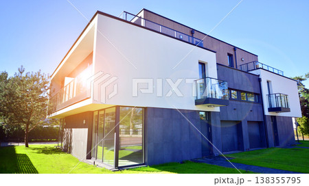 Terraced family homes in newly developed housing estate. The real estate market in the suburbs. New single family houses in a new development area. Residential homes with modern facade.  138355795