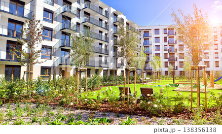 European residential architecture harmonizing with nature. Eco-friendly living in city with greens. Eco apartment building saving energy and fresh air concept.  138356138