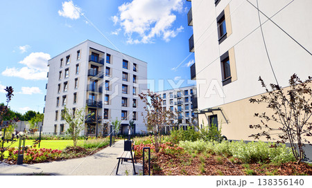 European residential architecture harmonizing with nature. Eco-friendly living in city with greens. Eco apartment building saving energy and fresh air concept.  138356140