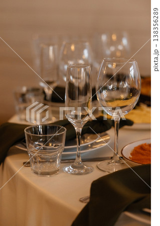 Chic Setup Of Beverage Glasses And Linens Illuminated Softly For Elegant Celebration Chic Setup Of Beverage Glasses And Linens Illuminated Softly For Elegant Celebration 138356289