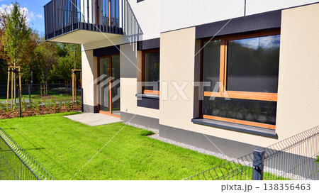 The garden of a modern residential building with a green lawn and a place to relax. Home garden. 138356463