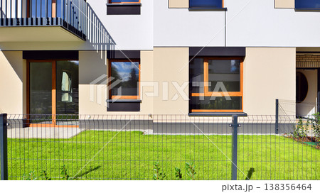 The garden of a modern residential building with a green lawn and a place to relax. Home garden. The garden of a modern residential building with a green lawn and a place to relax. Home garden. 138356464