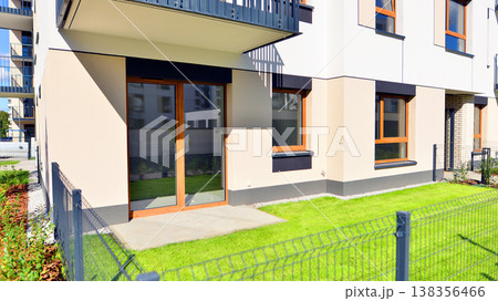 The garden of a modern residential building with a green lawn and a place to relax. Home garden. 138356466
