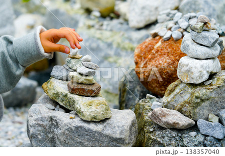 Relaxed spiritually child's hand arrangement pebble tower. Yoga relax meditation 138357040