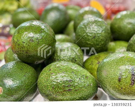 Large rifle green avocados harvested ready to eat are sold on supermarket shelves top view. Healthy eating. Close-up. 138359231
