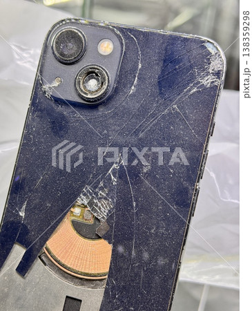 ALMATY, KAZAKHSTAN - FEBRUARY 27, 2025: The back of a broken glass gold side of a broken iPhone 13 Pro displayed on a showcase shelf in an electronics store. Close-up. ALMATY, KAZAKHSTAN - FEBRUARY 27, 2025: The back of a broken glass gold side of a broken iPhone 13 Pro displayed on a showcase shelf in an electronics store. Close-up. 138359298