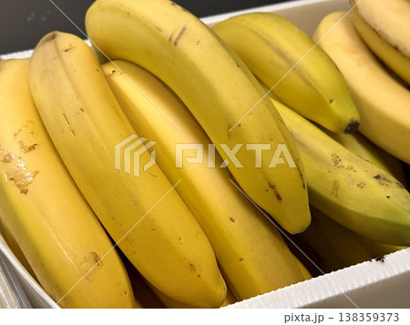 Ripe juicy yellow bananas close-up on a shelf in a supermarket. Close-up. 138359373