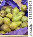 A bountiful collection of fresh, ripe green pears beautifully nestled in a charming basket, perfect for healthy eating. Close-up. 138359408