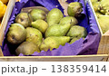 A bountiful collection of fresh, ripe green pears beautifully nestled in a charming basket, perfect for healthy eating. Close-up. 138359414
