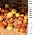 A vibrant and colorful display of fresh, crisp red apples organized neatly in a bustling market settings. Close-up. 138359416