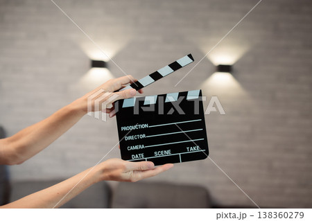 Hands holding clapperboard, signaling start of film production, cinematic movie making storytelling, industry concept Hands holding clapperboard, signaling start of film production, cinematic movie making storytelling, industry concept 138360279