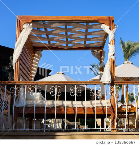 A comfortable sofa with a tent on the beach for a luxurious holiday A comfortable sofa with a tent on the beach for a luxurious holiday 138360667