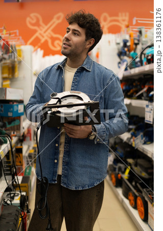 Man shopping for power tools in a diy store for home improvement project 138361176