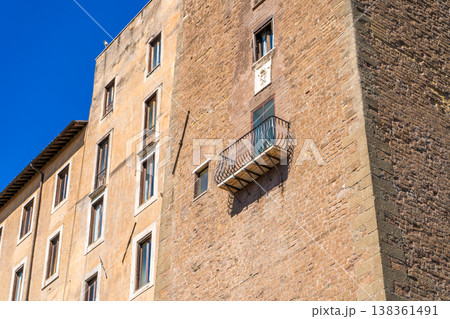 Brick wall house facade. Old building architecture in the city center Italy, Rome. Italian balcony. Brick wall house facade. Old building architecture in the city center Italy, Rome. Italian balcony. 138361491