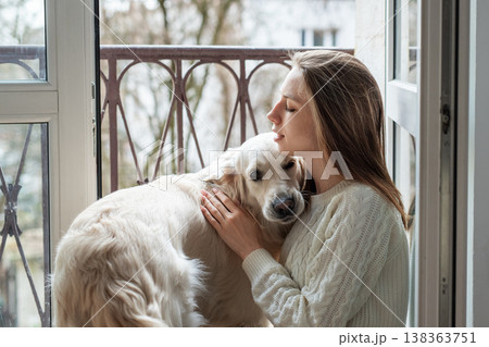 Woman bonding with golden retriever dog in home Woman bonding with golden retriever dog in home 138363751