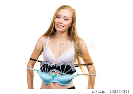 Woman holds bras, choosing Woman holds bras, choosing 138364591