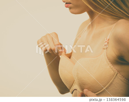 Woman wearing too big bra Woman wearing too big bra 138364598