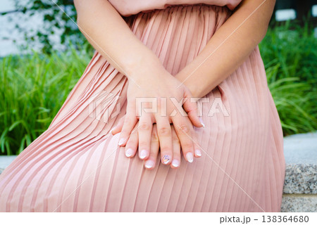 Woman wearing pink romantic pleated dress 138364680