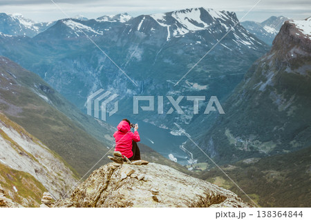 Tourist taking photo from Dalsnibba viewpoint Norway Tourist taking photo from Dalsnibba viewpoint Norway 138364844