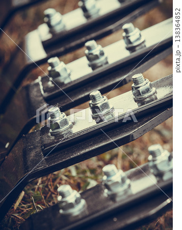 Closeup of ripper machinery rods with screws 138364852