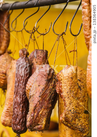 Smoked sausages meat hanging in smokehouse 138364905