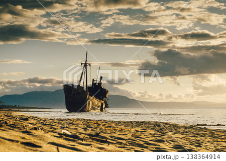 Rusty broken shipwreck on sea shore Rusty broken shipwreck on sea shore 138364914