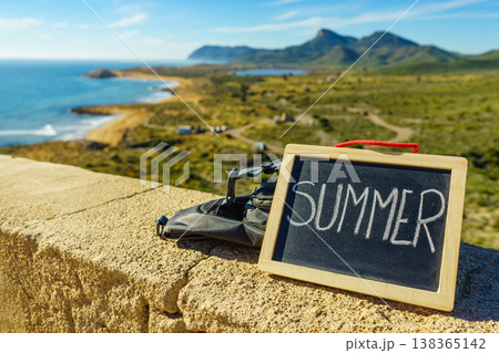 Black board with word summer against sea coast Black board with word summer against sea coast 138365142
