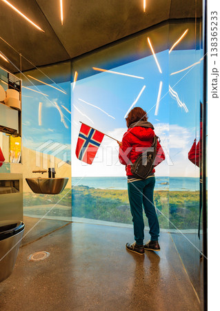 Tourist with norwegian flag in mirrored toilet, Andoy Norway Tourist with norwegian flag in mirrored toilet, Andoy Norway 138365233