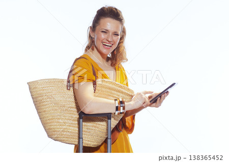 Happy Woman Using Smartphone While Preparing for Summer Travel Happy Woman Using Smartphone While Preparing for Summer Travel 138365452