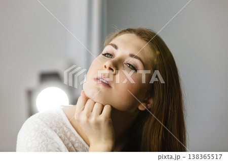 Attractive woman with long brown hair thinking Attractive woman with long brown hair thinking 138365517