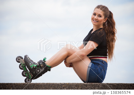 Young woman riding roller skates Young woman riding roller skates 138365574