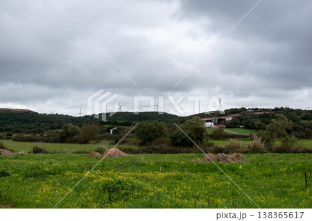 Rural landscape with wind turbines under a cloudy sky Rural landscape with wind turbines under a cloudy sky 138365617