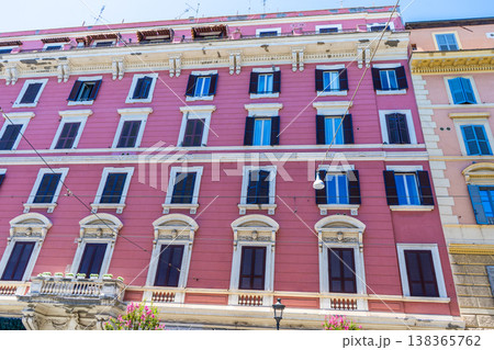 Italy Rome pink street house facade. Old building architecture in the city center. Italian window shutters Italy Rome pink street house facade. Old building architecture in the city center. Italian window shutters 138365762
