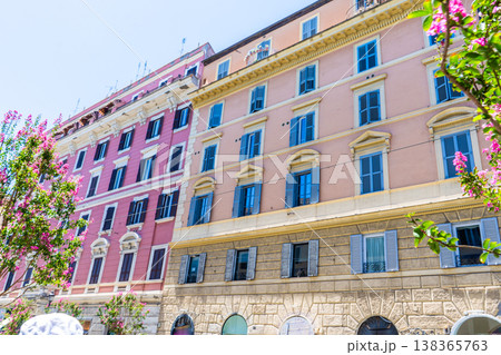 Italy Rome balcony street pink house facade. Old building architecture in the city center. Italian window shutters Italy Rome balcony street pink house facade. Old building architecture in the city center. Italian window shutters 138365763