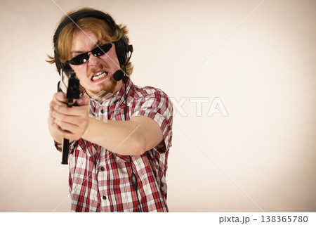 Gamer man shooting from gun Gamer man shooting from gun 138365780