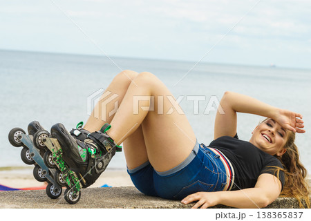 Girl wearing roller skates on seaside Girl wearing roller skates on seaside 138365837