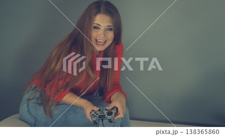 Young woman playing video games Young woman playing video games 138365860