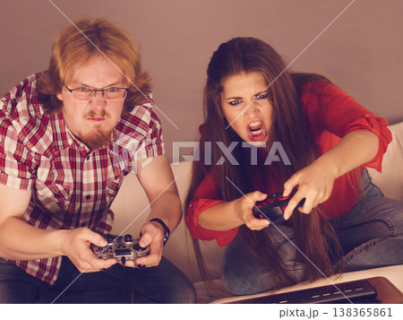 Addicted couple playing games Addicted couple playing games 138365861