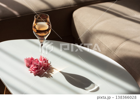 Rose Wine Glass with Shadows on White Table. Elegant Minimalist Scene 138366028