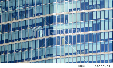 Modern office building with glass facade background. Transparent glass wall of office building. Modern office building with glass facade background. Transparent glass wall of office building. 138366074