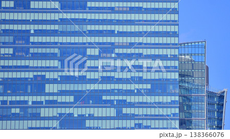 Modern office building with glass facade background. Transparent glass wall of office building. 138366076