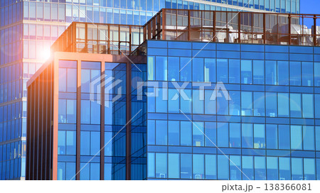 Modern office building with glass facade background. Transparent glass wall of office building. 138366081