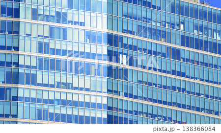 Modern office building with glass facade background. Transparent glass wall of office building. Modern office building with glass facade background. Transparent glass wall of office building. 138366084