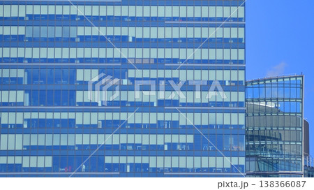 Modern office building with glass facade background. Transparent glass wall of office building. Modern office building with glass facade background. Transparent glass wall of office building. 138366087