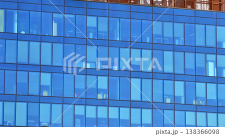 Modern office building with glass facade background. Transparent glass wall of office building. 138366098