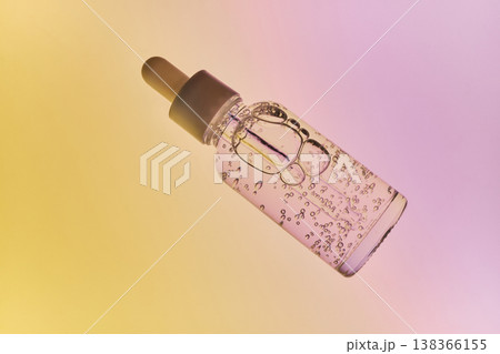 Beauty serum bottle with pipette showing liquid and bubbles for cosmetic wellness Beauty serum bottle with pipette showing liquid and bubbles for cosmetic wellness 138366155